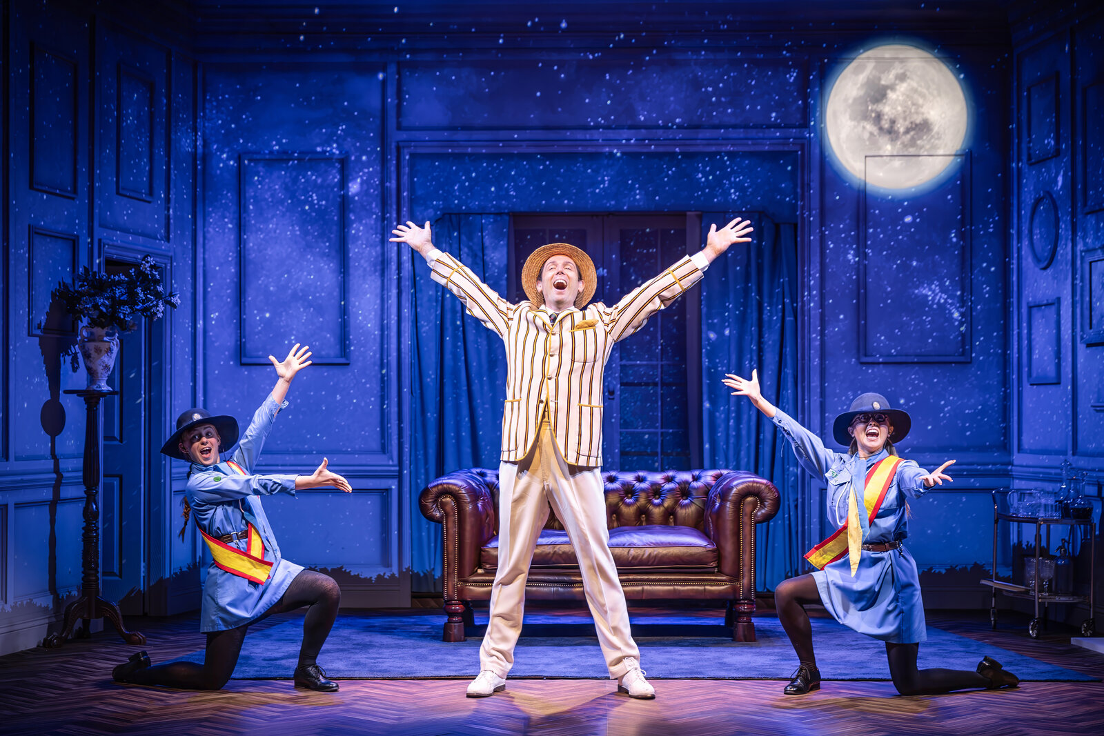 Sam Harrison under a full moon with two Girl Guide characters, Jeeves Takes Charge