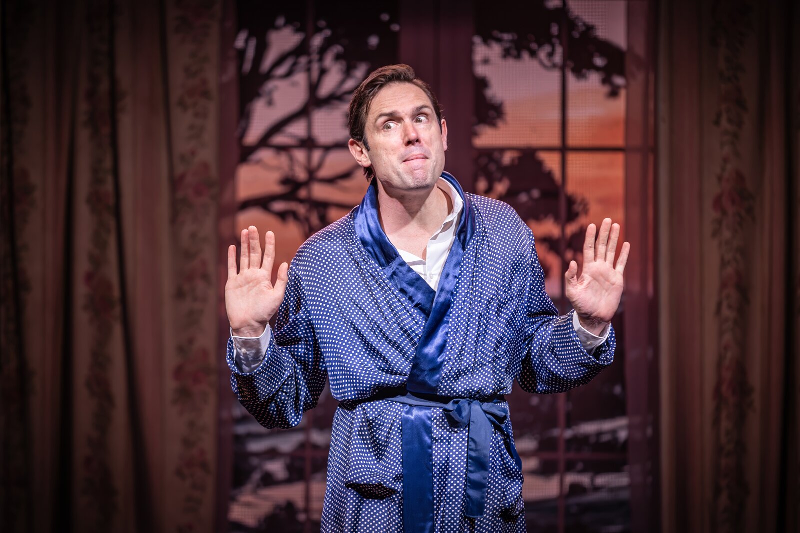 Sam Harrison in a polka-dot dressing gown, hands raised, Jeeves Takes Charge